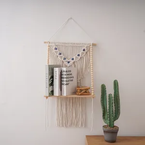 Boho wall hanging shelf detail, handmade woven cotton tapestry with wooden beads and eye.