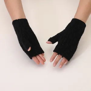 Winter black knitted fingerless gloves detail, cozy warm solid color yarn hand wear.