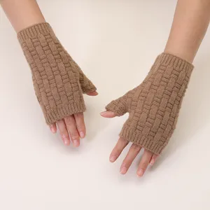 Close-up detail view of women's winter knitted half-finger gloves, warm and cozy brown yarn.
