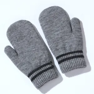 Detail view of grey knit mittens with black stripes, winter warm fuzzy gloves close up.