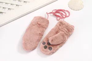 Close-up detail of cute pink plush winter mittens featuring soft cat paw pads and warm string.