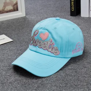Light blue baseball cap with sparkling silver Sweetie letter embroidery and pink heart.