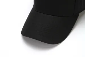 Black baseball cap detail shot, classic curved brim design with neat stitching for daily wear.