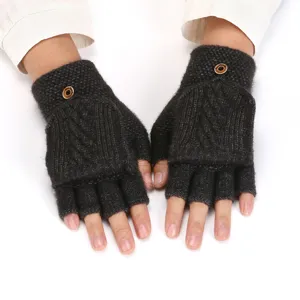 Detail view of dark grey knitted half finger convertible gloves with cable knit and buttons.
