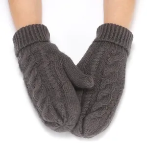 Close-up detail of thick cable-knitted winter mittens in dark grey, warm and cozy fabric.