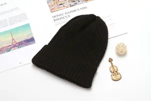 Detailed view of a classic black knitted beanie hat, warm and stylish winter headwear.