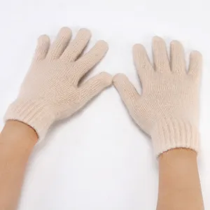 Close-up of warm beige knitted five-finger gloves showing soft fluffy texture for winter.