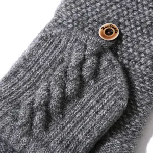 Gray cable knit fingerless gloves detail shot featuring cozy texture and wooden button.