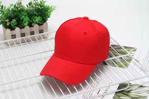 Close-up detail of the plain red cotton baseball cap on white wire rack for casual outdoor wear.