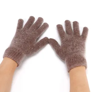 Close-up detail of fuzzy brown knit five-finger winter gloves showing soft fluffy texture.