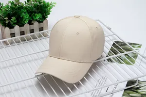 Close-up detail of a plain beige cotton baseball cap, breathable and casual for outdoor use.