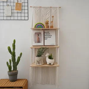 Bohemian handmade woven fringe 3-tier wooden wall hanging shelf detail view for home decor storage.