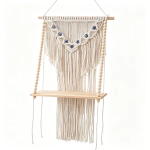 Bohemian macrame wall hanging shelf with evil eye beads, handmade wooden floating shelf decor.
