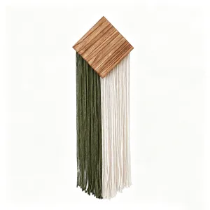 Détail de tenture murale en coton tissé fait main avec accent en bois et franges bicolores.