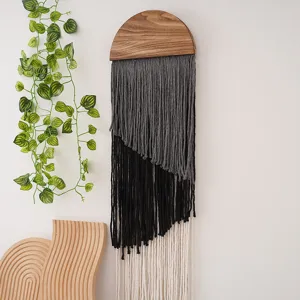 Handcrafted macrame wall hanging with wooden top and gradient tassel design for boho home decor.