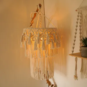 Handmade macrame pendant lamp shade detail, bohemian style woven cotton light fixture closeup.