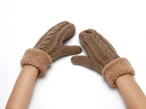 Detailed view of winter warm knitted mittens with plush fleece cuff, cozy cable knit texture.