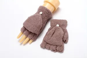 Close-up detail of soft fleece convertible fingerless gloves with cute button and warm winter design.