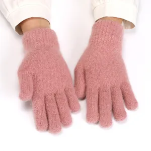 Close-up detail of soft pink fuzzy knitted gloves showing plush texture and warm five-finger design.