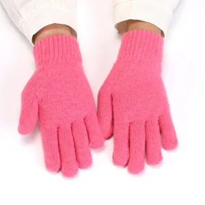 Pink knit gloves close up detail showing warm plush texture and five finger winter design.