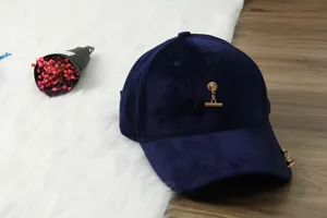 Navy blue velvet baseball cap with chic gold chain detail, stylish curved brim accessory.