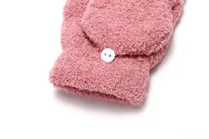 Close-up detail view of women's plush fleece convertible mittens in solid pink with button.
