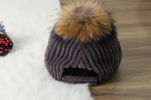 Detailed view of women autumn winter thick corduroy baseball cap with fluffy fur pom pom.