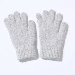 Close-up of fluffy grey knit gloves detail, soft texture and warm winter material.