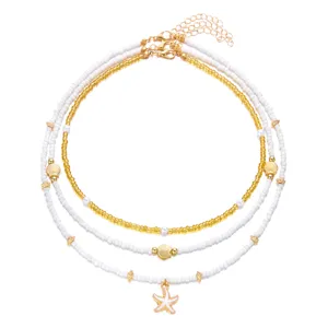 Close-up detail shot of the multi-layer beaded beach necklace showing delicate shells and starfish charms.