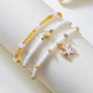 Charming beaded bracelet set with starfish and shell charms, perfect for summer beach style.