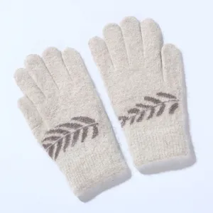 Detailed close-up of warm knitted winter rabbit hair gloves with elegant brown leaf print.