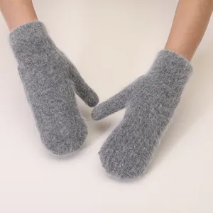 Detailed view of fluffy winter warm mittens for women, soft plush fuzzy gloves in solid grey color.
