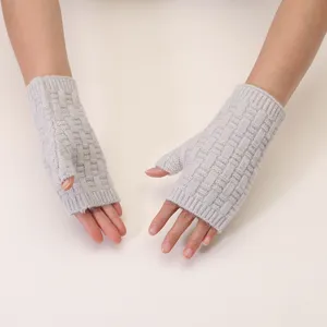 Close-up detail of grey knitted fingerless gloves, winter warm ribbed wool handwear.