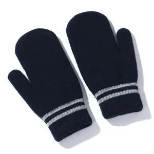 Close-up detail of dark blue knitted winter mittens featuring elegant double silver stripes.