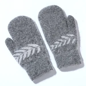 Grey fuzzy knit mittens detail shot, winter warm rabbit hair gloves with elegant leaf pattern.