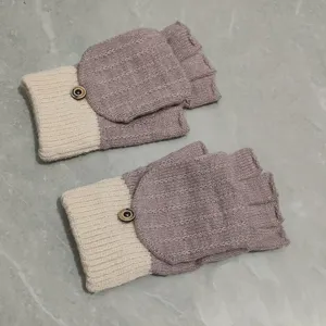 Detailed view of winter knit convertible fingerless gloves in beige and dusty purple.