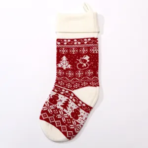 Large knitted Christmas stocking in red and white jacquard pattern for holiday decor.