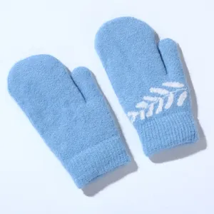 Light blue winter knitted mittens with a white leaf pattern, cozy and warm for cold days.