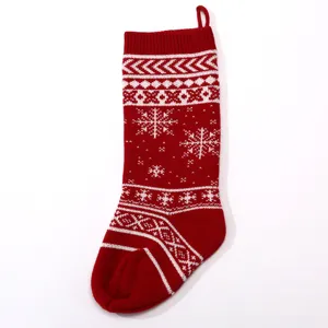 Large knitted Christmas stocking with festive snowflake pattern, ideal for holiday gift bags and decor.