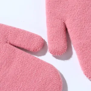Pink knit mittens detail view showing soft woolen texture and warm winter design.