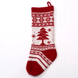 Red and white knitted Christmas stocking detail, featuring tree and snowflake design.