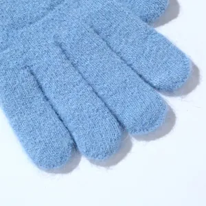 Light blue knitted fuzzy gloves winter warm soft texture five finger detail close up photo