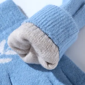 Close-up detail shot of winter thick fleece lined knitted warm gloves in blue tone.