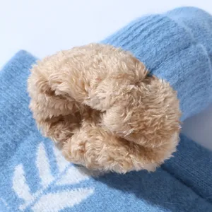Close-up view of winter warm knitted mitten showing soft plush fuzzy faux fur lining texture.