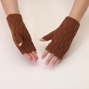 Detailed view of brown cable-knit fingerless gloves, showing delicate texture and warm wear.
