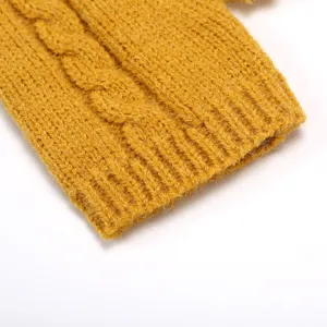 Close-up detail of cozy yellow cable-knit arm warmer sleeve cuff with soft texture.