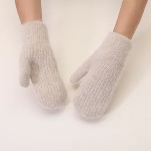 Cozy fluffy knit mittens detail shot, soft plush warm winter gloves close-up view texture