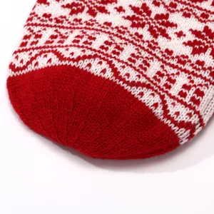 Detailed shot of Christmas knitted stocking with red and white Nordic jacquard pattern.
