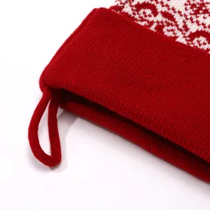 Knit Christmas stocking detail shot, red and white jacquard pattern, holiday gift bag.