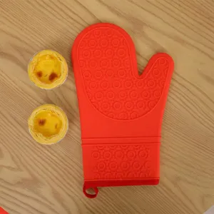 Red silicone oven mitt for baking, heat resistant kitchen glove with anti-slip textured design.